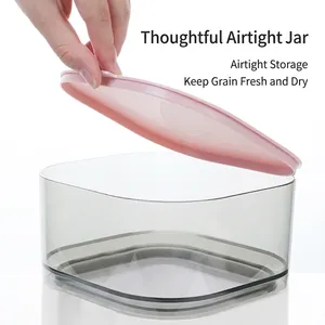 Automatic pet feeder with gray translucent container and pink lid for dog food storage