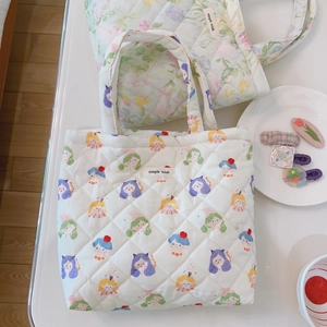 French floral and cartoon quilted cotton tote bags with simple wish label on white desk