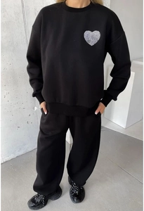 Close-up of black round neck sweatshirt set featuring a white heart fingerprint print