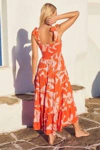 Detail of cross-back tie straps and large floral print on a summer vacation dress
