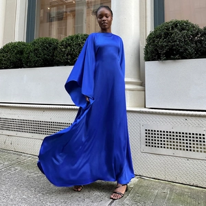Detail of royal blue satin maxi dress showing the flowing fabric and batwing sleeve