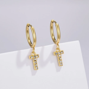 Close-up of golden T-letter earrings with sparkling pavé white zircon stones