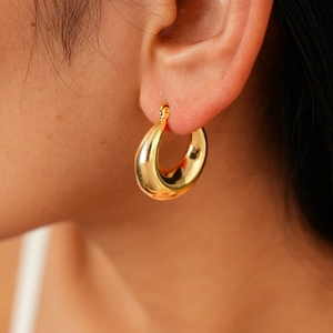 Minimalist gold teardrop chunky hoop earrings with a smooth polished metallic finish