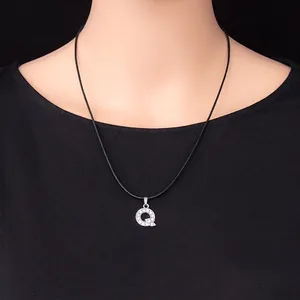 Silver letter Q pendant necklace encrusted with rhinestones on a black cord