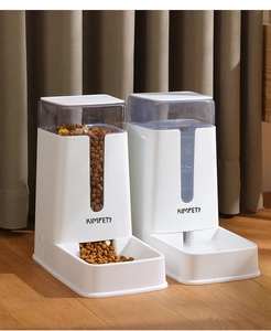 Detail view of automatic pet feeder and water dispenser set on a modern wood floor