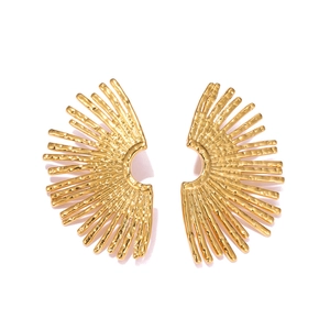 Detailed view of golden sunbeam earrings with unique hammered texture and metallic finish