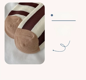 Detailed macro view of reinforced toe on classic striped cotton socks for durability