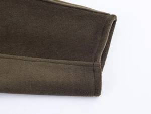 Detailed view of heavy olive wool fabric showing precise double-needle stitching on cuff
