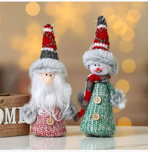 Detail of handmade knit Christmas gnome ornaments with plush hats and wooden buttons