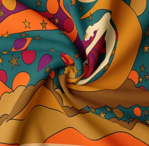 Detail of bohemian tapestry fabric showing psychedelic planet print and soft texture
