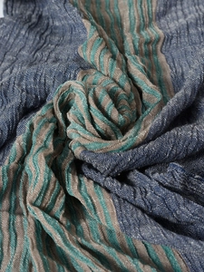 Macro detail of the navy blue striped woven fabric showing texture and soft pleats