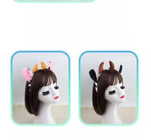 Detail of cute plush cow ear headbands in pink and black colors for party costumes