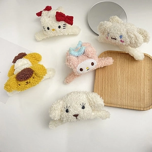 Detail of soft Sanrio-style plush hair claws with cute cartoon character designs
