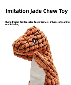 Detail of orange dinosaur plush dog toy with textured corn-kernel fabric for teeth cleaning