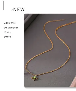 Detail of 18k gold plated necklace with green zircon four-leaf flower pendant