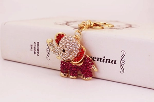 Detailed close-up of a golden elephant keychain with sparkling red and white rhinestones
