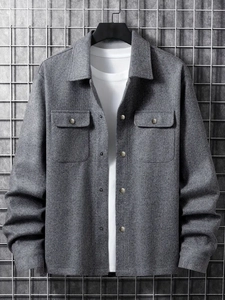 Detailed view of men's grey corduroy work jacket with flap pockets and silver buttons
