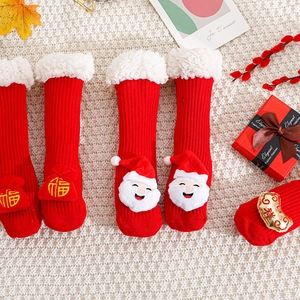 Christmas children's sherpa socks with Santa and fortune charms on knit background