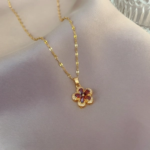 Luxurious 18K gold titanium necklace with pomegranate red flower pendant and crystals
