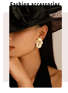 Close-up of elegant 18k gold daisy stud earrings worn by a model in a vintage hat