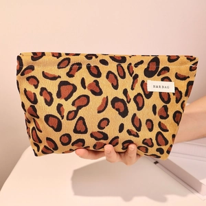 Handheld vintage leopard corduroy cosmetic bag for travel and storage with label