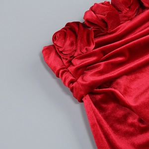 Detailed view of red velvet evening dress featuring hand-made 3D rose floral decoration
