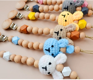 Detail of assorted crochet bunny pacifier clips with natural beech wood beads