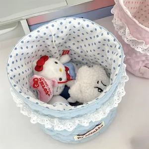 Close-up of quilted heart basket with lace trim and polka dot lining in pastel colors