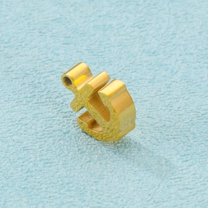 Detailed macro view of a gold-plated stainless steel anchor pendant for DIY jewelry crafts