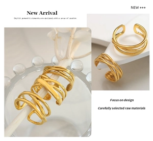 Close-up of gold geometric C-shaped layered ring with polished metallic finish