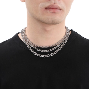 Close-up of triple layered silver stainless steel O-chain necklaces with OT toggle clasp