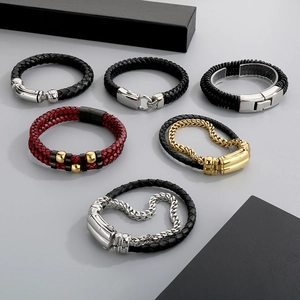 Macro detail of men's leather braided bracelets with steel spring clasps and multi-layer texture