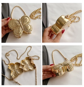 Golden butterfly-shaped metal evening bag with bead chain strap from multiple views
