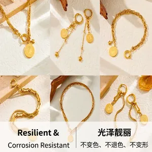 Detail of vintage gold plated coin necklaces and star earrings on beige stone texture