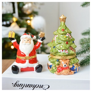 Detail showing ceramic Santa and Christmas tree jewelry boxes with gold hinges