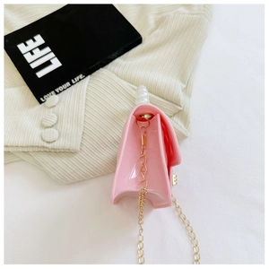 Detailed side view of pink transparent jelly bag with pearl handle and golden chain