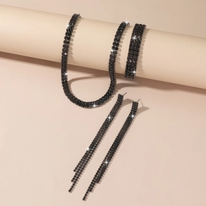 Close-up of black rhinestone jewelry set including necklace, fringe earrings, and bracelets