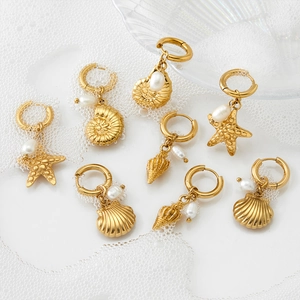 Golden ocean theme earring set featuring starfish, shell and pearl on white water background