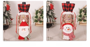 Detail of burlap Christmas wine bottle covers with Santa Claus and Snowman embroidery