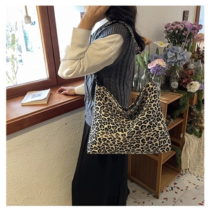 Close-up of stylish leopard print canvas tote bag showing large capacity and texture