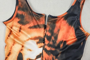 Detail of tiger print jumpsuit featuring a front zipper and U-shaped neckline