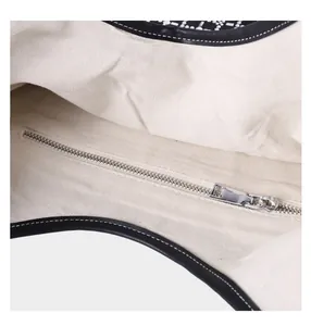 Close-up of canvas interior lining and silver metal zipper pocket on luxury diamond bag