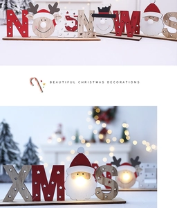 Detail of wooden XMAS letter sign with LED lights and Santa Claus festive desktop decor