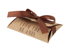 Detail of kraft pillow gift box featuring a brown satin bow and elegant printed text
