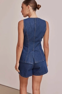 Dettaglio completo di set denim blu scuro con spacco posteriore e taglio attillato