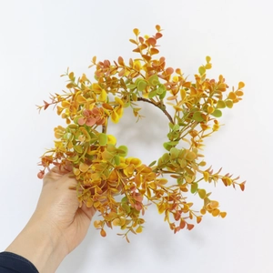 Autumn eucalyptus candle ring wreath with orange and yellow leaves for harvest decor