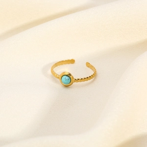 Detailed macro shot of vintage gold adjustable ring featuring a turquoise stone and rope texture