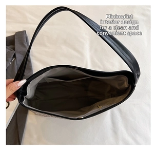 Top view of large black tote bag interior showing grey lining and spacious main compartment
