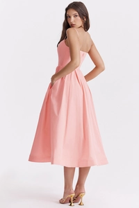 Detail view of the pale pink backless midi dress with thin straps and a classic A-line silhouette