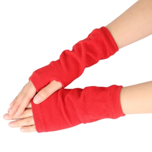 Close-up of red knitted arm warmers featuring fingerless design and ribbed texture